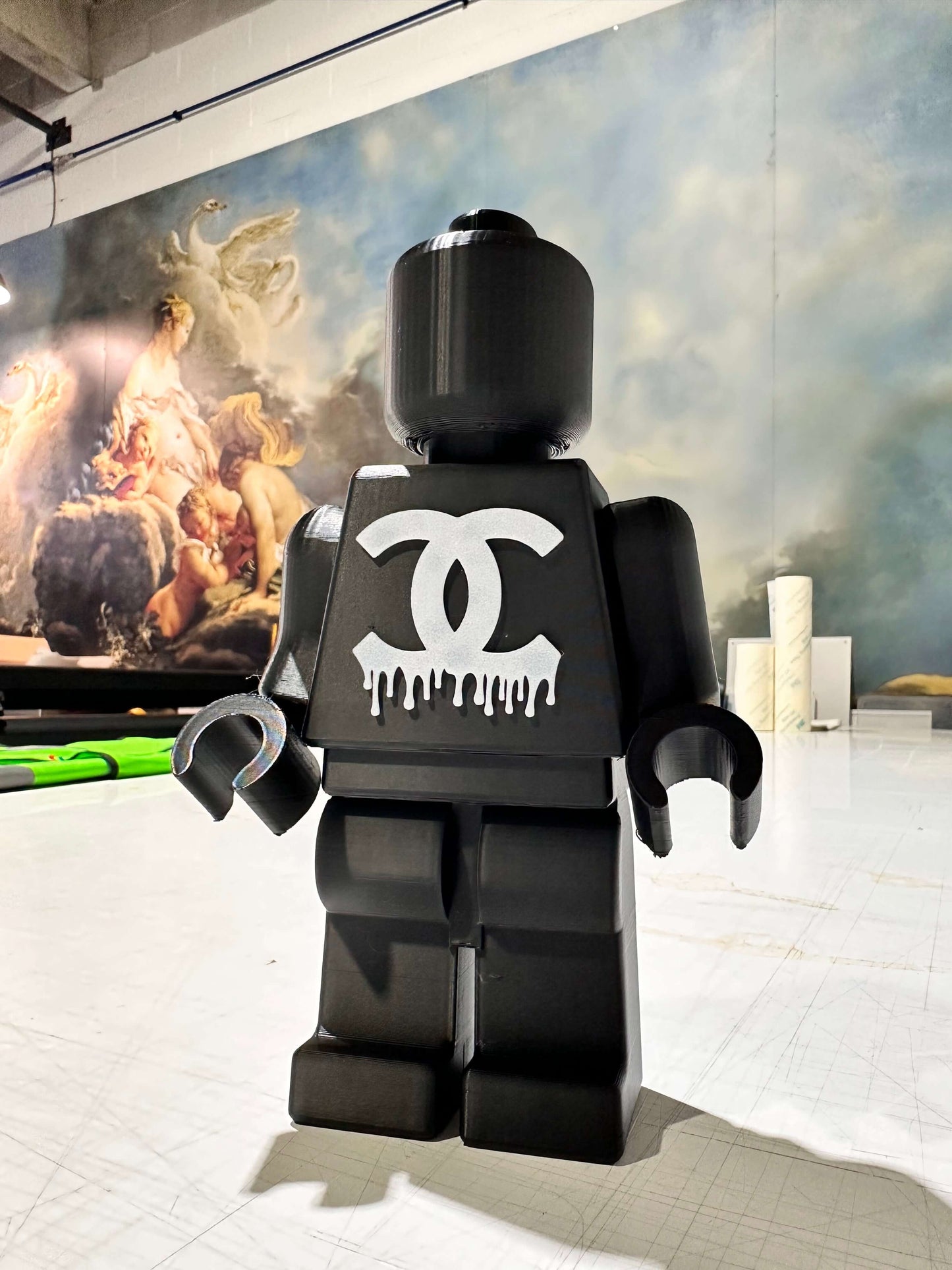 Mini figure Lego in black with dripping logo, showcasing 3D art style perfect for decor.