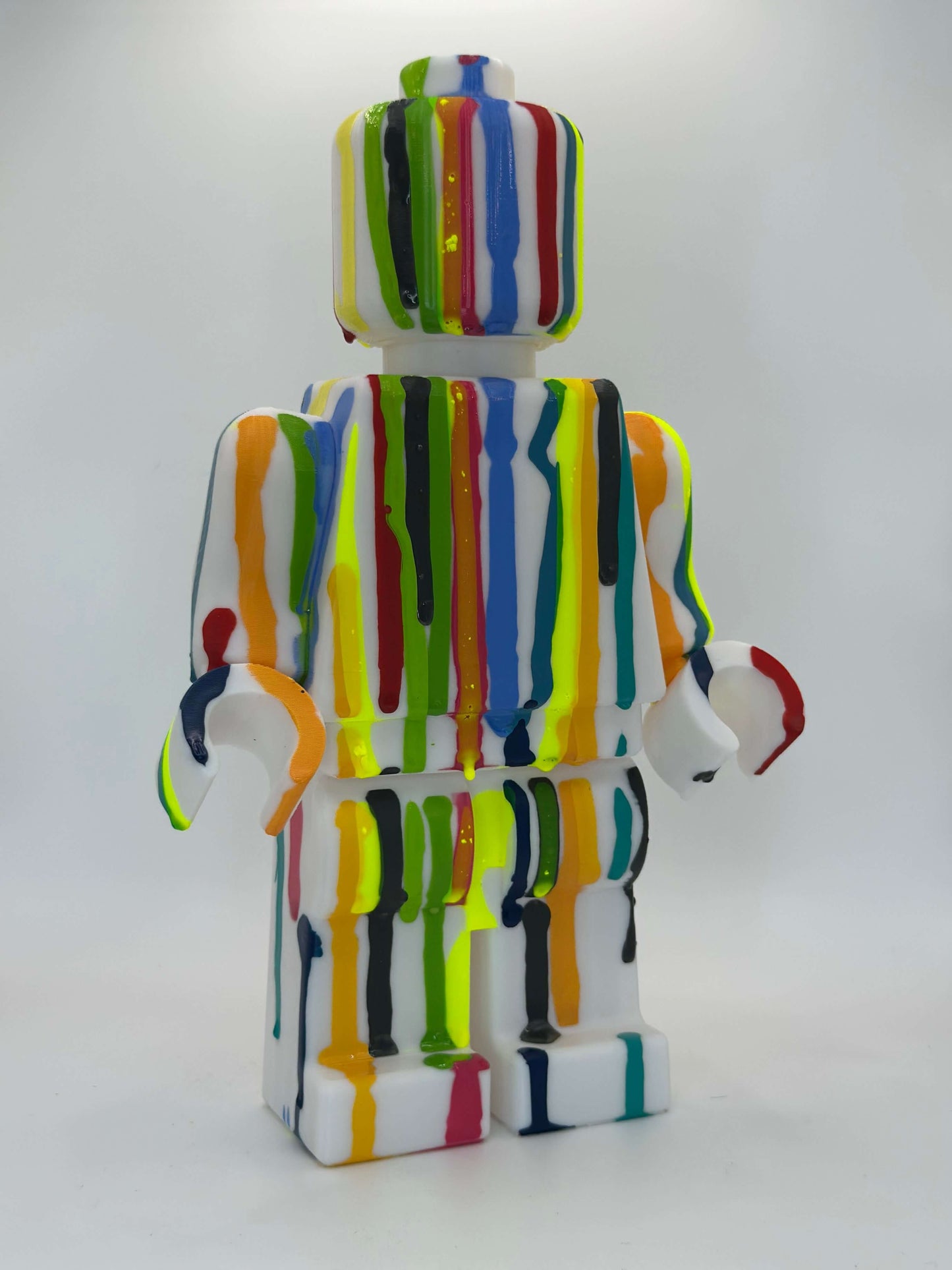 Maxi Figure Lego in colorful pop art style, custom 3D printed statuette with vibrant paint drips.