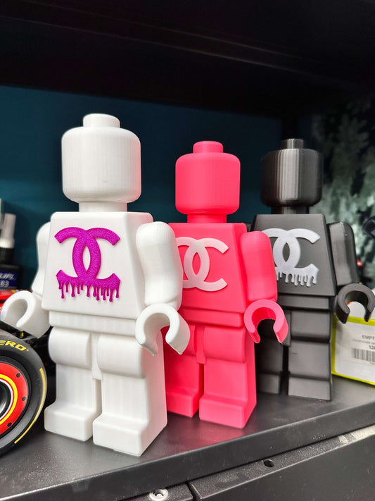 Mini figure Lego with colorful CC logo, featuring pink, white, and black designs for pop art decor.